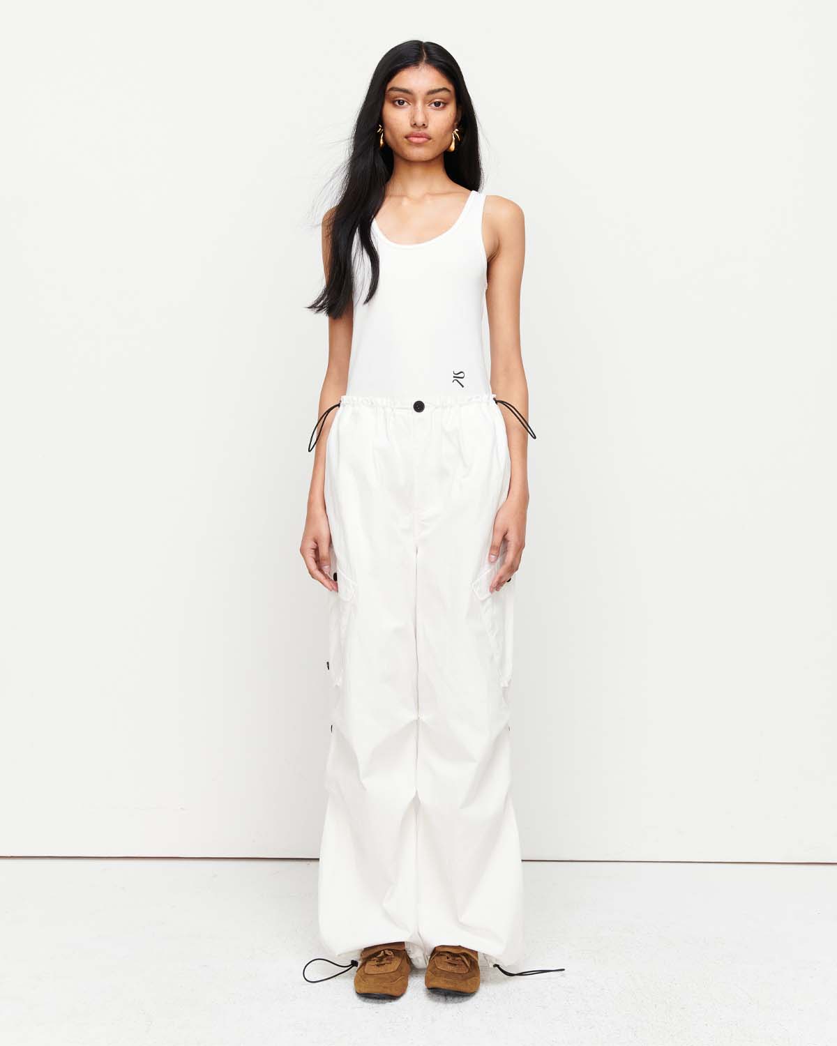 The Romy Cargo Pant in white is a relaxed trouser silhouette, crafted from a premium cotton blend fabrication. Designed for easy wear, it features a wide leg shape, an adjustable drawstring cord through the waist and finished with a toggle fastening. Show now.