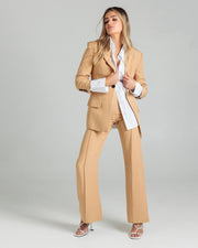 DESCRIPTION:The Classic Blazer by Romy is the perfectly tailored piece. Pair yours back with the coordinating pants or shorts. Designed for an oversized fit, if you prefer a closer to the body fit we recommend sizing down. DETAILS:96% Polyester 4% Spandex.Made in ChinaFully Lined.Button Cuff detail.Slight oversized shaping. Size down for a more tailored fit. CARE:Dry clean only. SIZE AND FIT:Model is size 8 and wearing a size S. By Romy. 